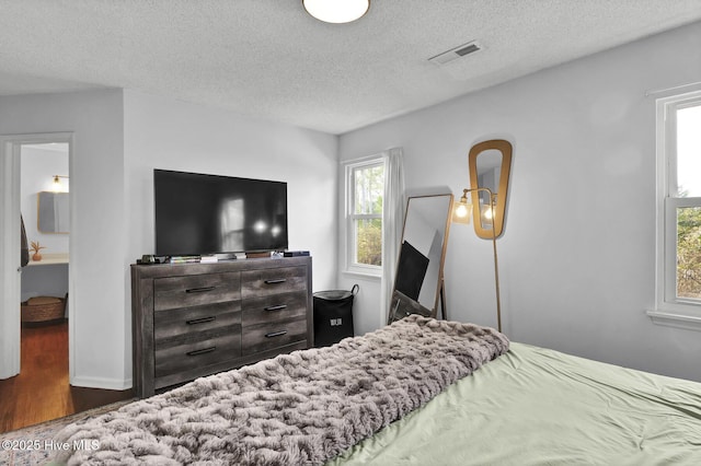 bedroom featuring dark wood-type flooring and a textured ceiling