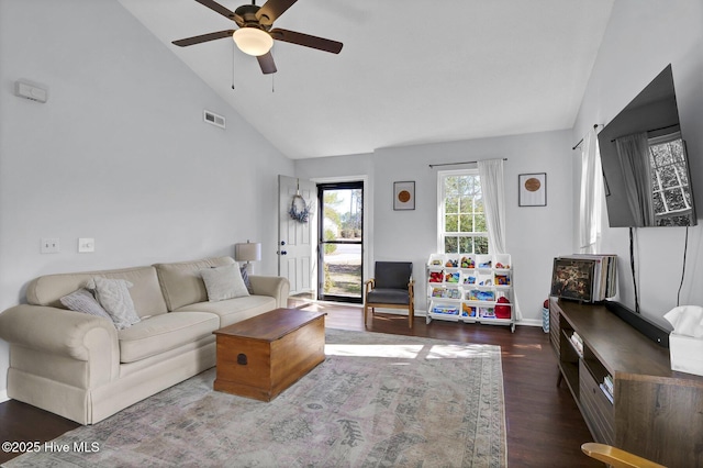 living room featuring ceiling fan, dark hardwood / wood-style floors, and high vaulted ceiling