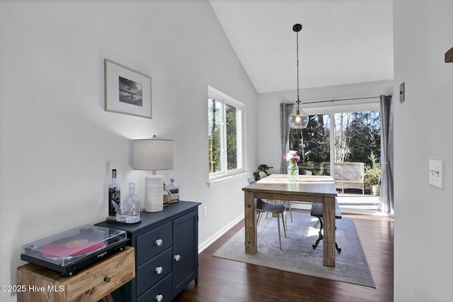 dining room with dark hardwood / wood-style flooring and vaulted ceiling