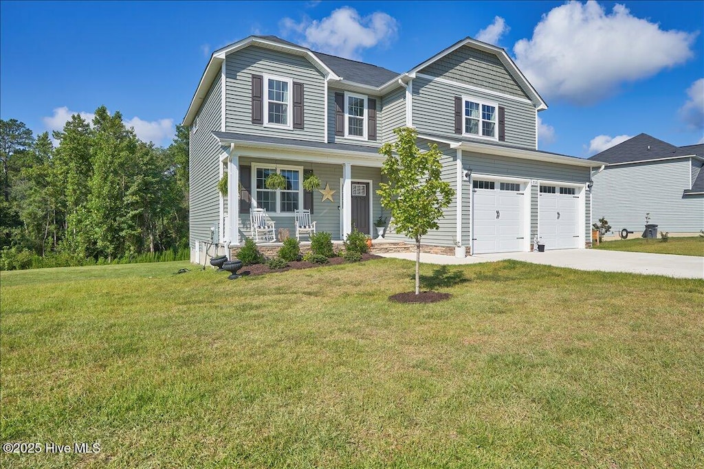 view of front of property with a garage, covered porch, and a front lawn