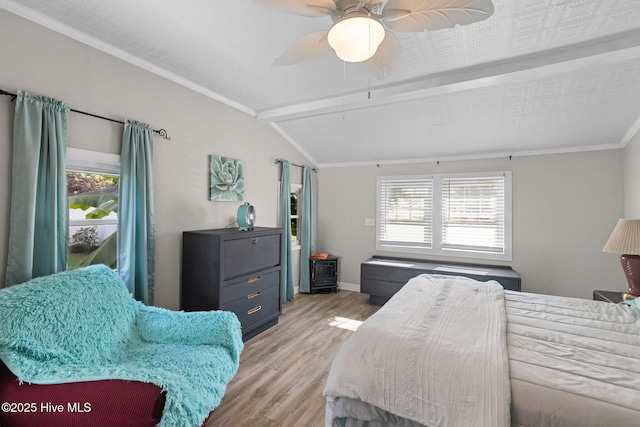 bedroom featuring ceiling fan, light wood-type flooring, crown molding, and lofted ceiling