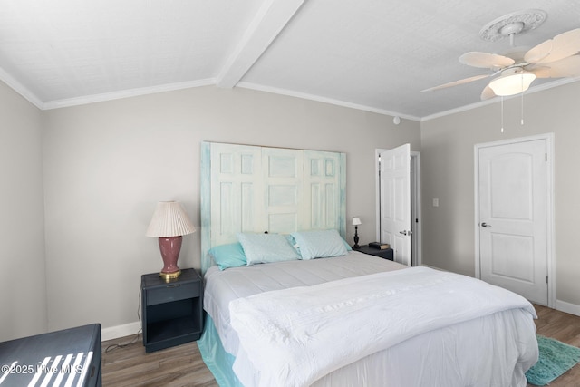 bedroom with ceiling fan, lofted ceiling with beams, light wood-type flooring, a closet, and ornamental molding