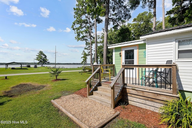 deck featuring a lawn and a water view