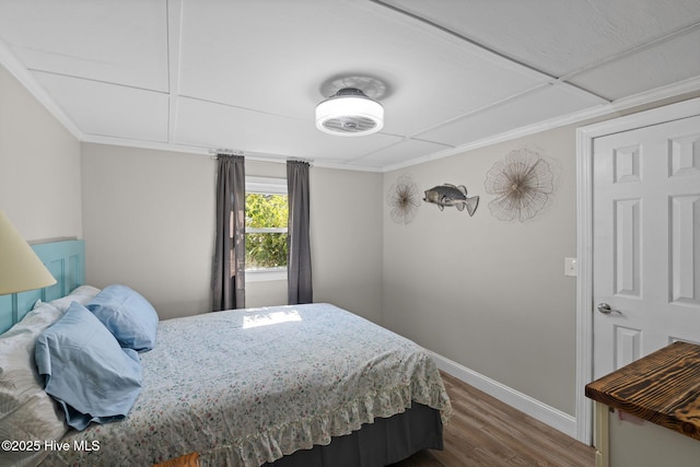 bedroom featuring hardwood / wood-style floors and ornamental molding