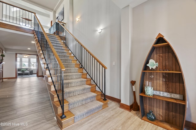 staircase with hardwood / wood-style flooring