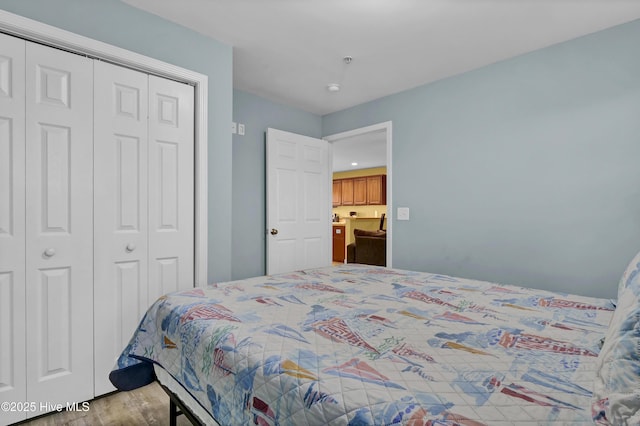 bedroom featuring light wood-type flooring and a closet