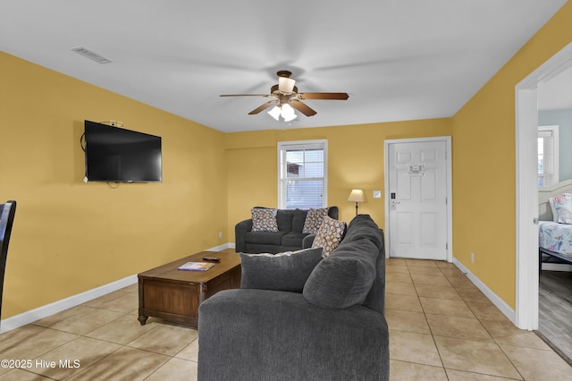 tiled living room featuring ceiling fan