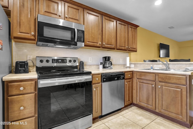 kitchen featuring light tile patterned floors, sink, and appliances with stainless steel finishes