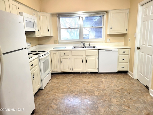 kitchen with white appliances, light countertops, and a sink