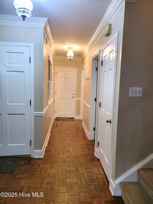 hall featuring stairway, baseboards, and ornamental molding