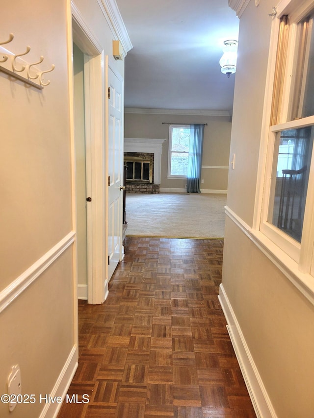 corridor featuring baseboards and ornamental molding