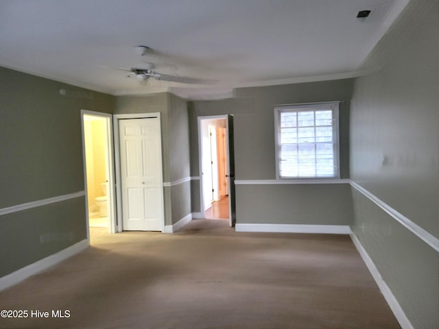 unfurnished bedroom featuring carpet flooring, baseboards, a closet, and ceiling fan