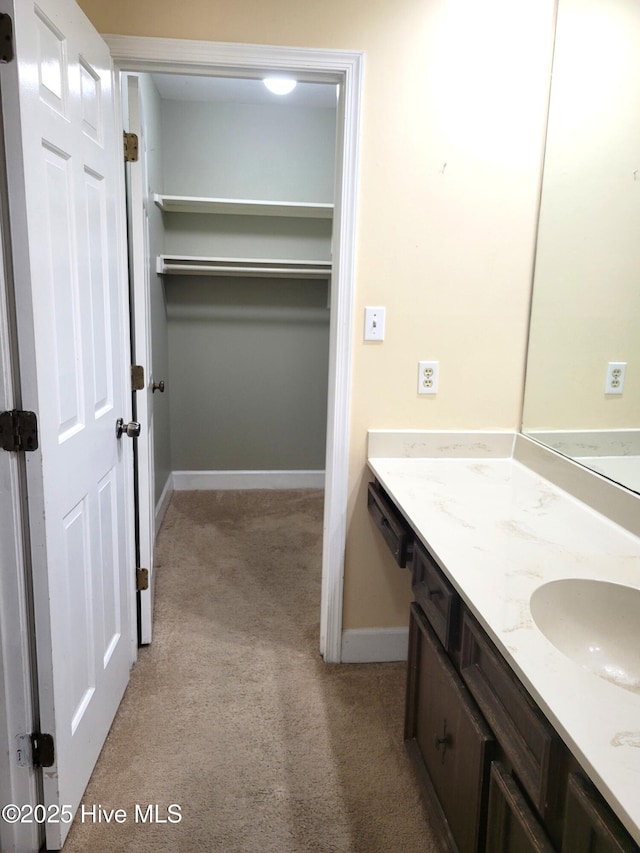 bathroom featuring baseboards and vanity