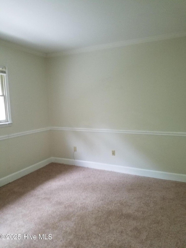 empty room featuring baseboards and carpet floors