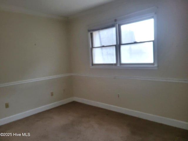 unfurnished room featuring carpet flooring and baseboards