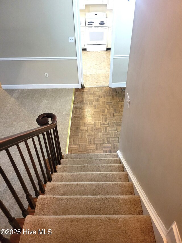 stairway featuring baseboards