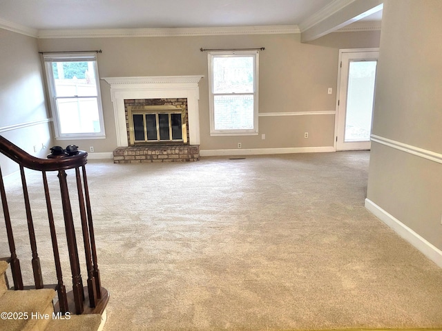 unfurnished living room with plenty of natural light, crown molding, and carpet floors