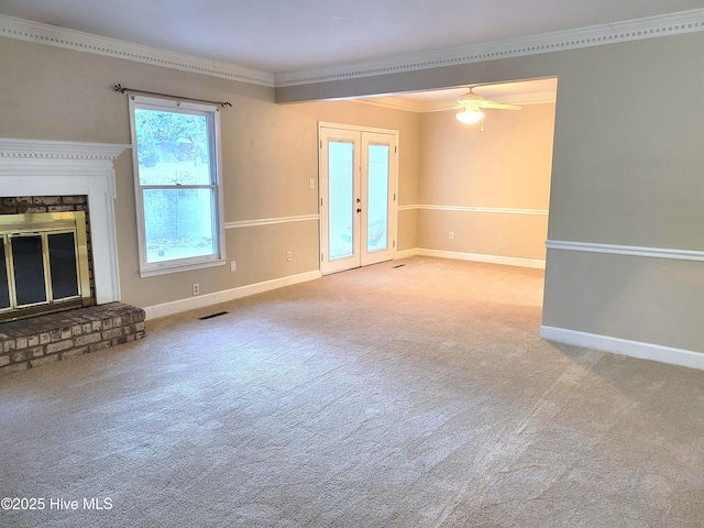 unfurnished living room featuring visible vents, baseboards, ornamental molding, carpet floors, and french doors