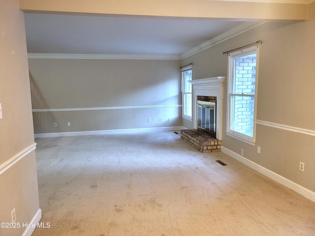 unfurnished living room with visible vents, crown molding, baseboards, and carpet floors