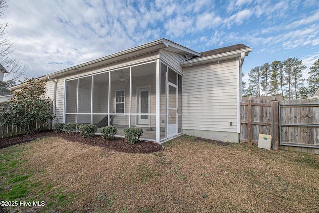 back of house featuring a yard, ceiling fan, and a sunroom