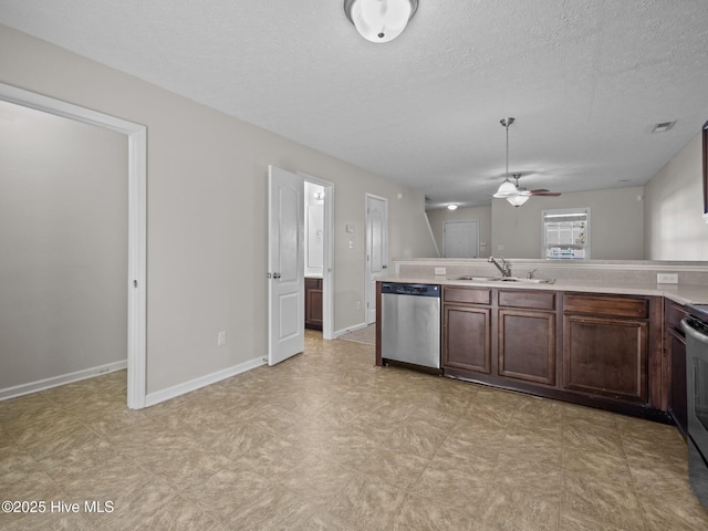 kitchen featuring a textured ceiling, stainless steel appliances, ceiling fan, dark brown cabinets, and sink