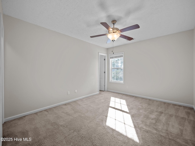 unfurnished room featuring a textured ceiling, light carpet, and ceiling fan