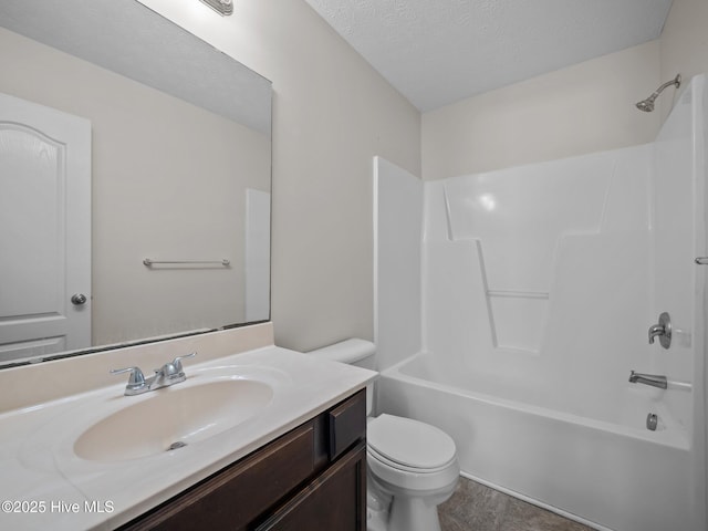 full bathroom with toilet, vanity, a textured ceiling, and bathing tub / shower combination