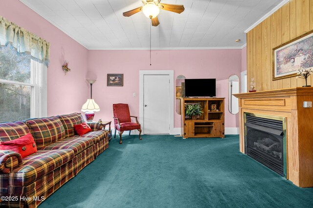 living room with dark colored carpet, wood walls, and ornamental molding