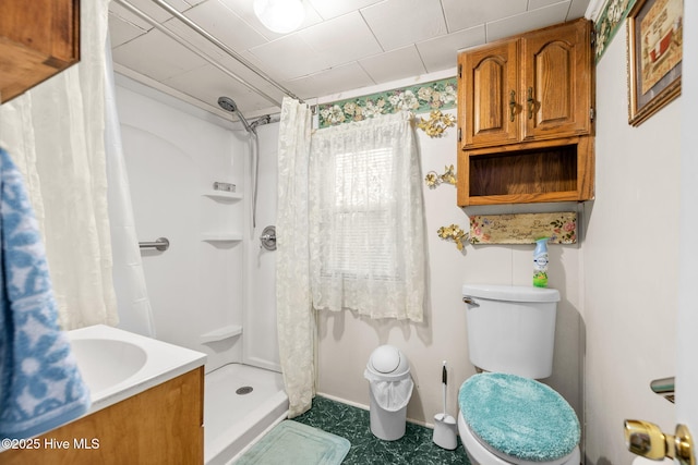 bathroom featuring toilet and walk in shower