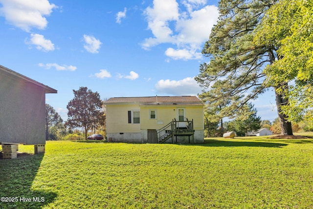 back of property featuring a yard