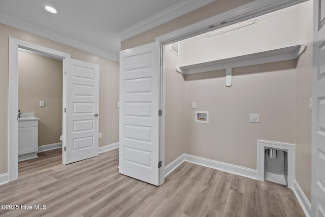 laundry area featuring crown molding, hookup for a washing machine, light hardwood / wood-style floors, and hookup for an electric dryer