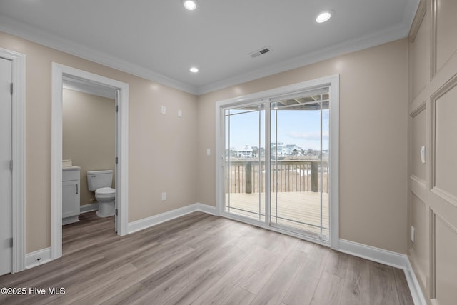 unfurnished bedroom featuring access to outside, ensuite bath, light hardwood / wood-style floors, and crown molding