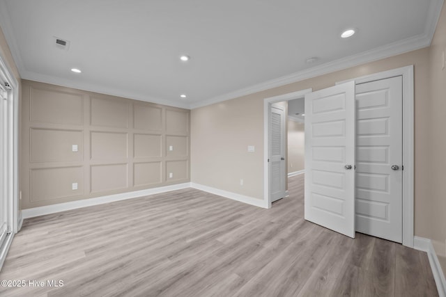 unfurnished bedroom featuring crown molding and light hardwood / wood-style flooring