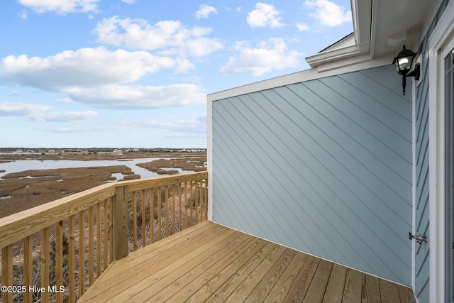 wooden terrace with a water view