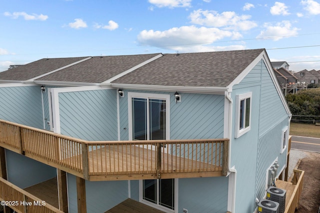 back of house with cooling unit and a balcony