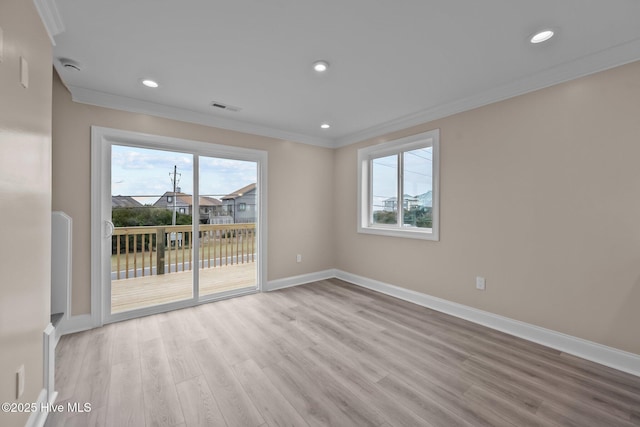 empty room featuring light hardwood / wood-style floors and ornamental molding