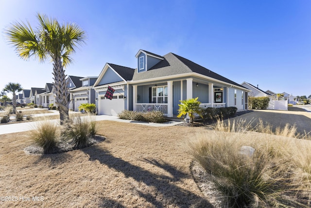 view of front of home featuring covered porch and a garage