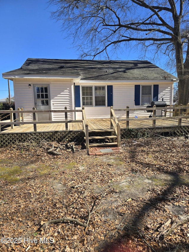 back of property featuring a wooden deck