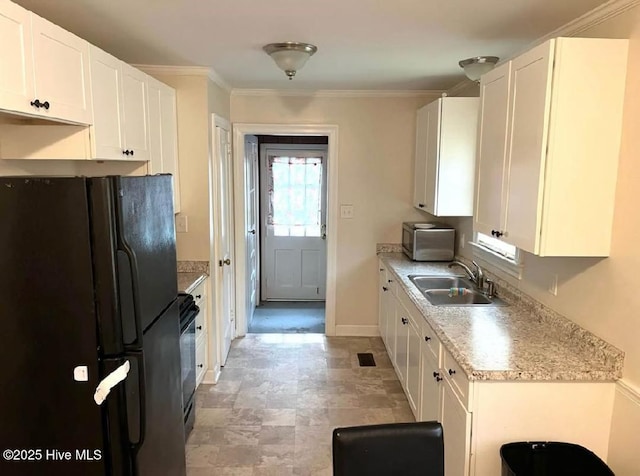 kitchen featuring black appliances, crown molding, white cabinets, and sink