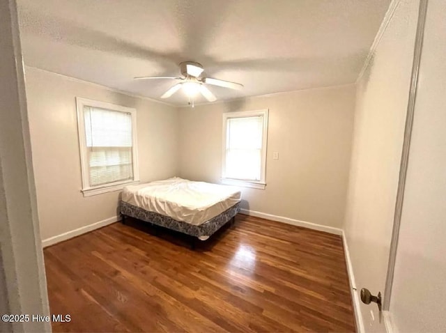 bedroom featuring dark hardwood / wood-style flooring and ceiling fan