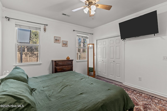 bedroom with a closet, ornamental molding, and ceiling fan