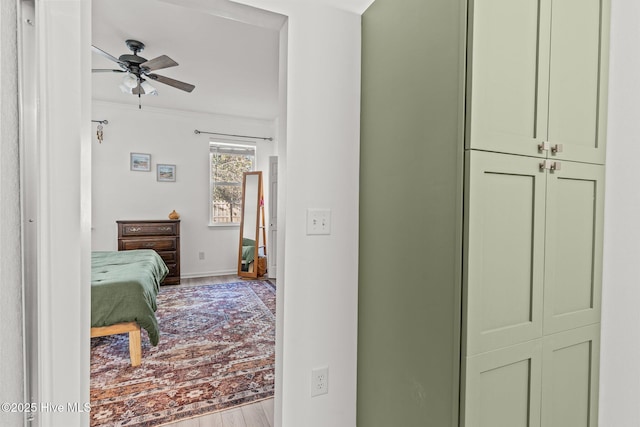 hall with ornamental molding and light hardwood / wood-style floors