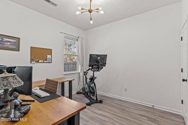 office space with an inviting chandelier and hardwood / wood-style floors