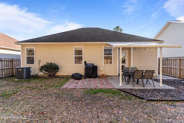 rear view of property featuring central air condition unit and a patio area