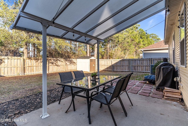 view of patio featuring a grill and a storage shed