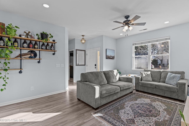 living room featuring ceiling fan and hardwood / wood-style floors