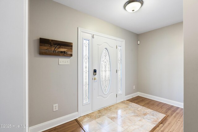 living room with hardwood / wood-style flooring, plenty of natural light, and ornate columns