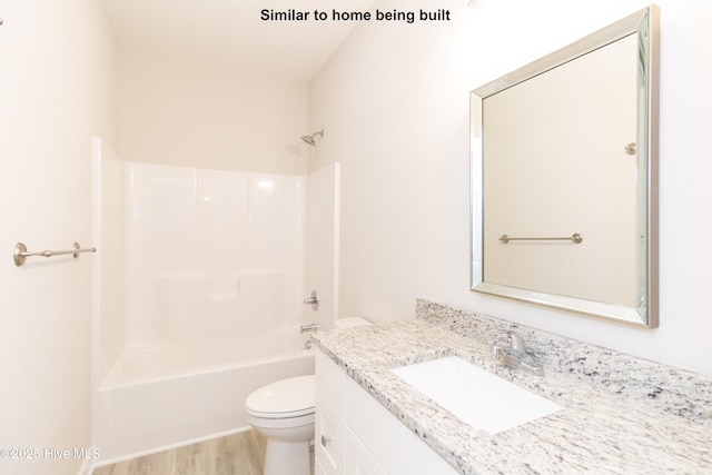 full bathroom featuring toilet, vanity, shower / washtub combination, and hardwood / wood-style flooring