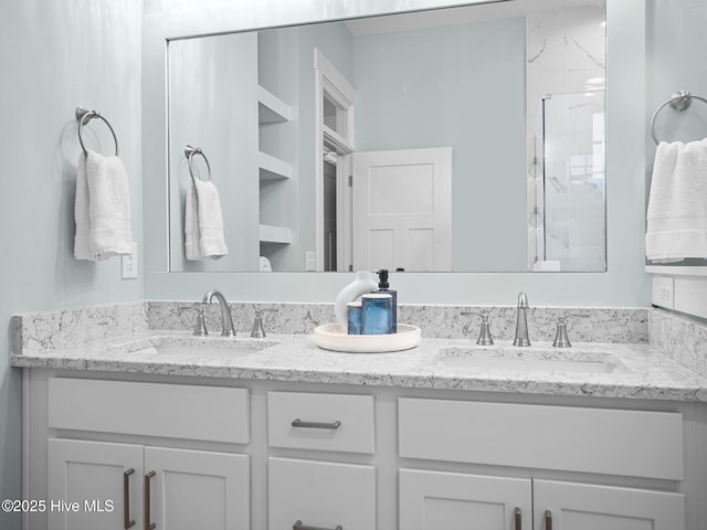 bathroom with built in features, vanity, and an enclosed shower