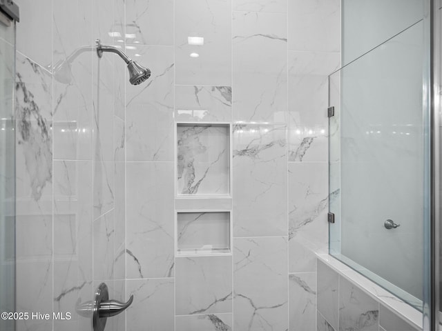 bathroom with a shower with shower door